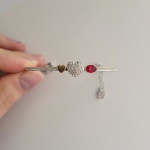 Elegant Silver and Gold Heart Bracelet with Red Gemstone